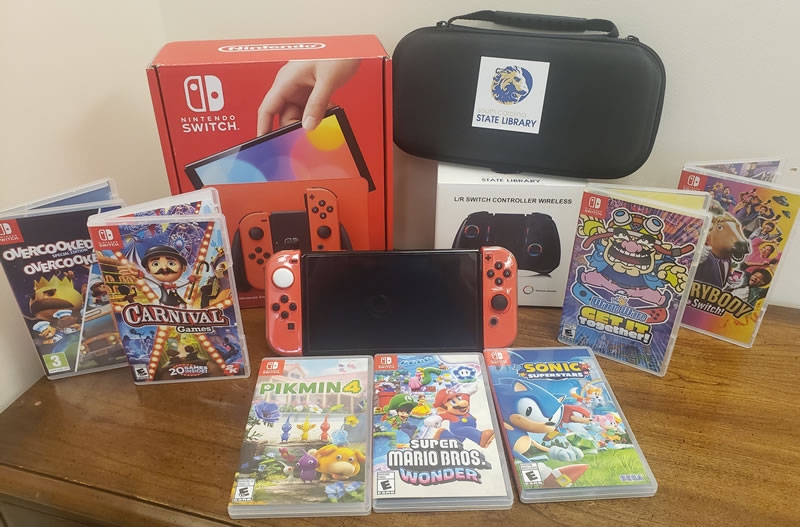Photo of Nintendo Switch and a selection of games.