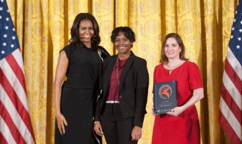 Education Coordinator Ellen Balkin and teen docent Kayla Curley receive the award from First Lady Michelle Obama for the Ogden Museum of Southern Art
