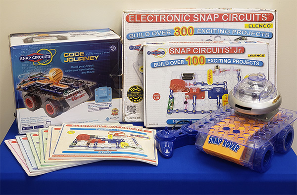Snap Circuits kit on a blue table.