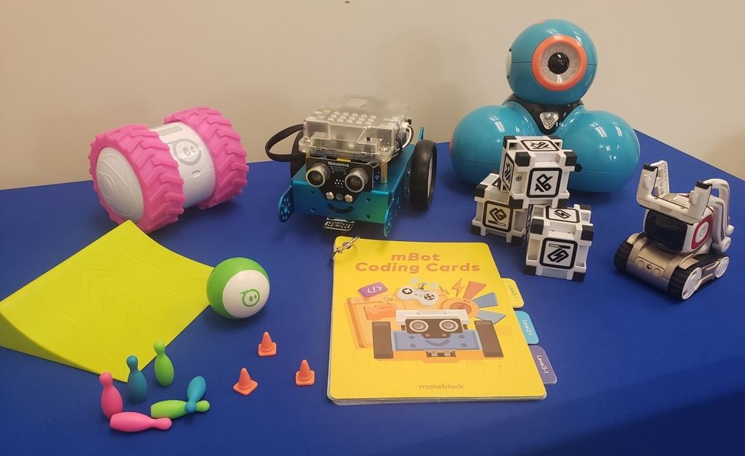 Robotic toys on a blue table.