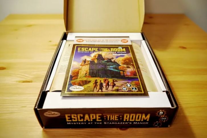 Mystery of Stargazers Manor game on a wooden table.