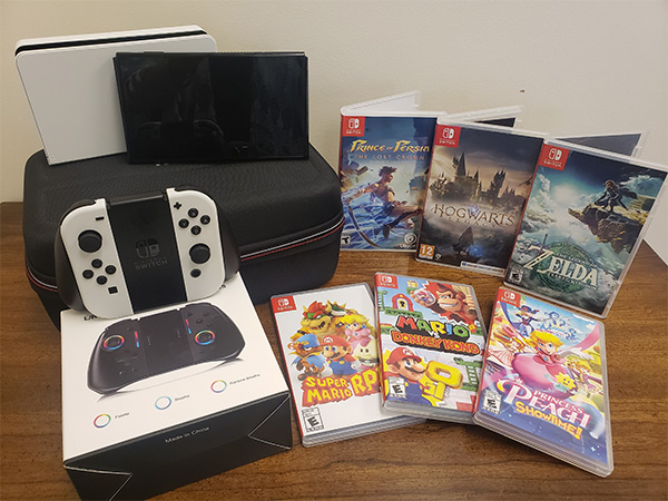 Nintendo Switch 3 on a table with a selection of games.