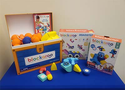 Blockaroo boxes on a blue table.
