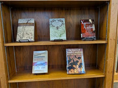 Selection of books on SC Native Americans on a bookshelf.