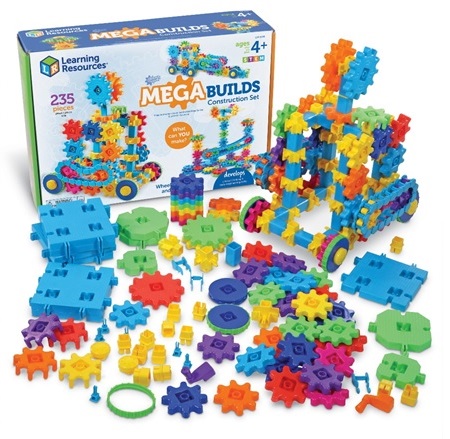 A selection of plastic, brightly colored gears on a table and the Mega Gears box behind them.