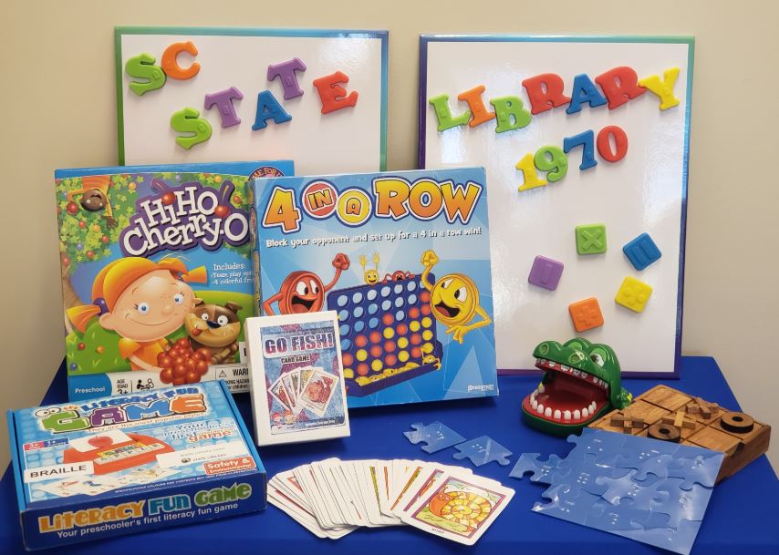 A selection of accessible games on a blue table.