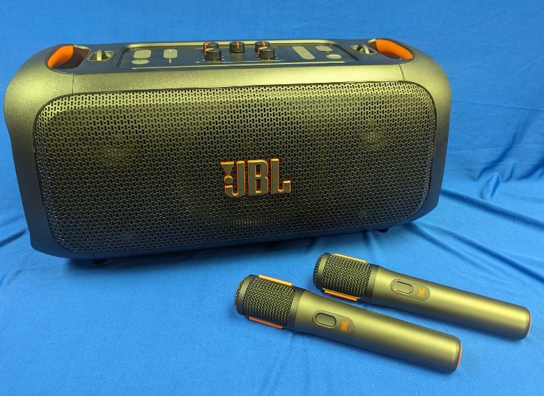 Speaker and microphones on a blue table.