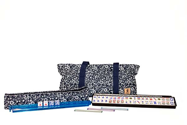 Mahjong tiles and decorative carrying bags on a white background.