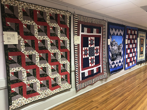 Quilts of Valor hanging at the Horry County Museum, from Facebook.