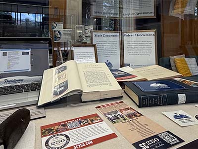 Image of the display case with books and historical artifacts.