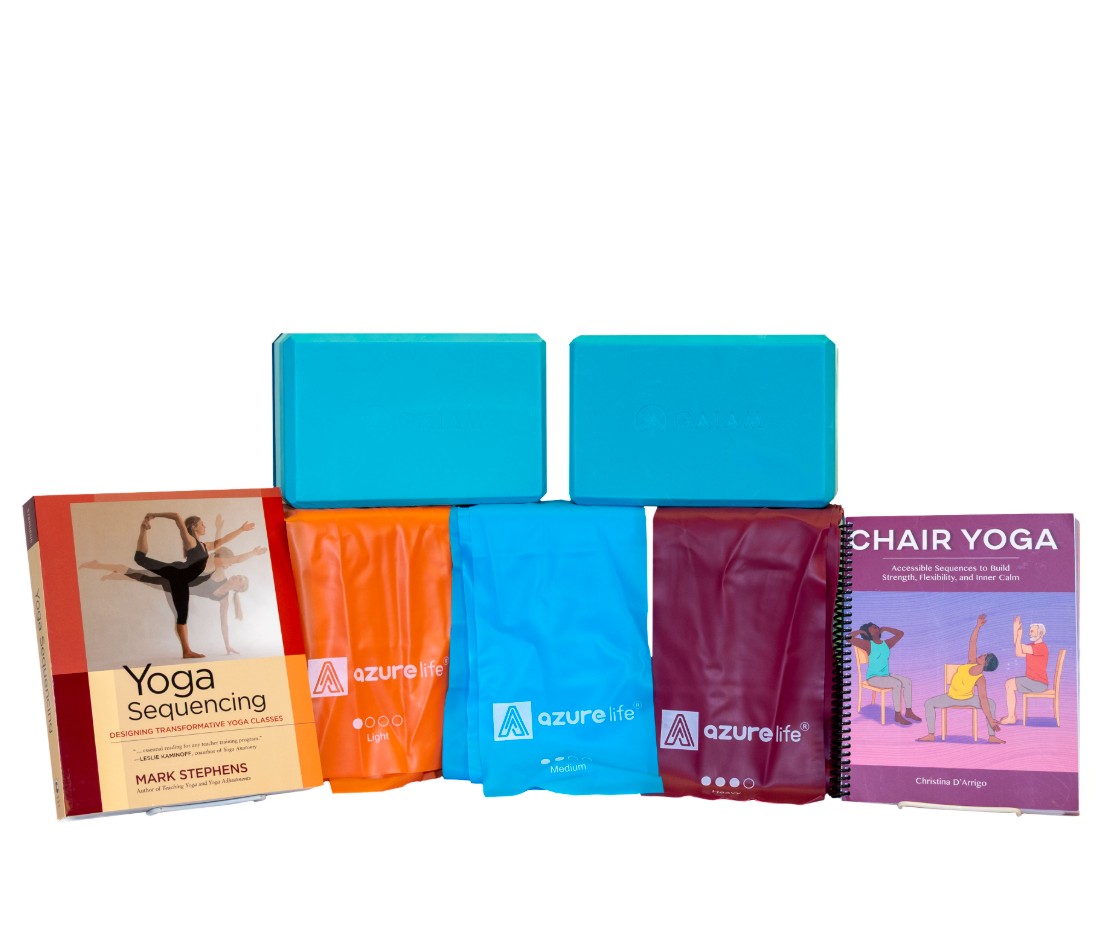 Yoga foam blocks, elastic bands, and yoga books on a white background.