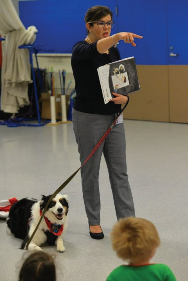 Ellen and Katie reading to school children.