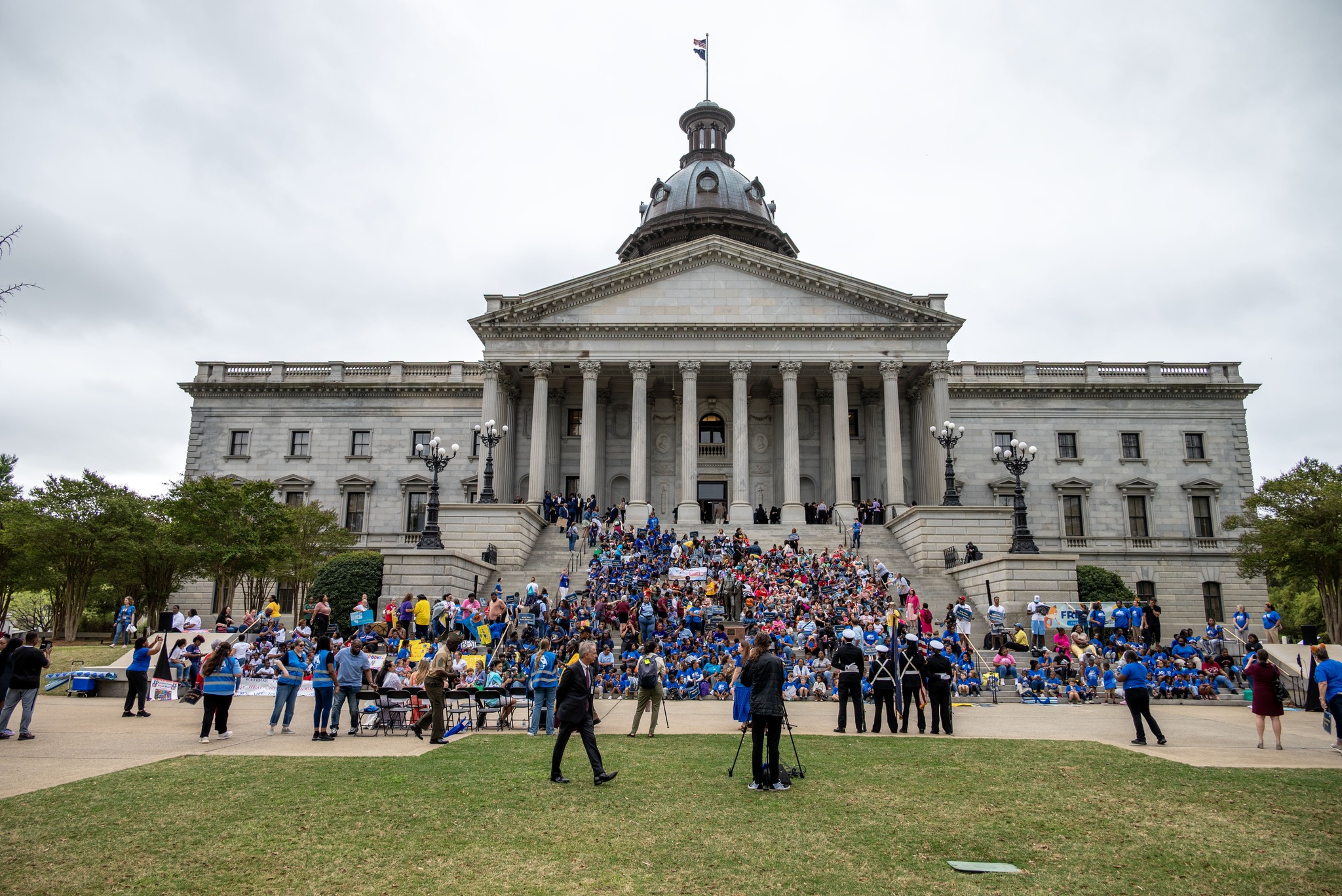Students sitting on the State House steps during presentations at the 2025 Read-In.
