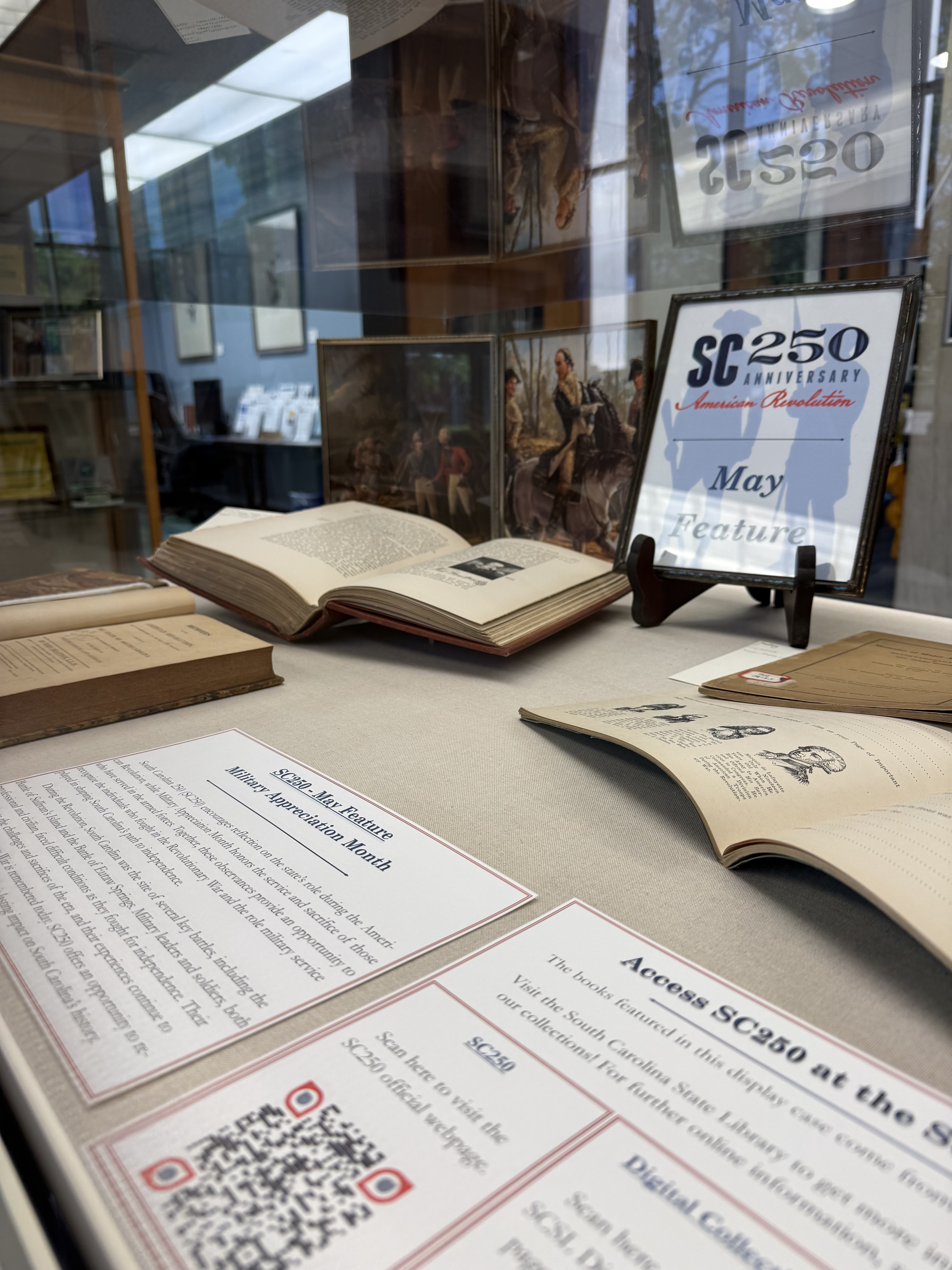 Display case featuring books and signage.