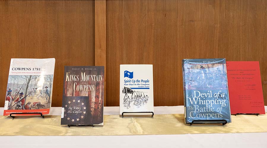 A selection of books on Revolutionary art on a table.