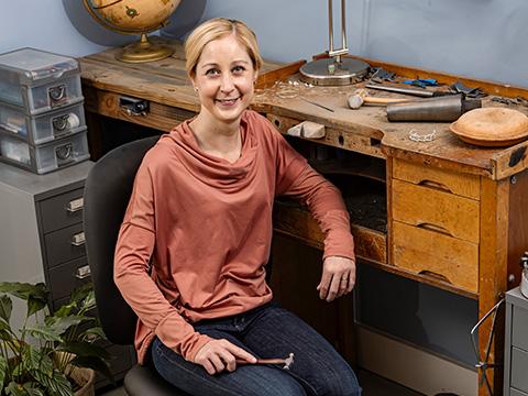 Kaminer Haislip sitting at her workshop table.
