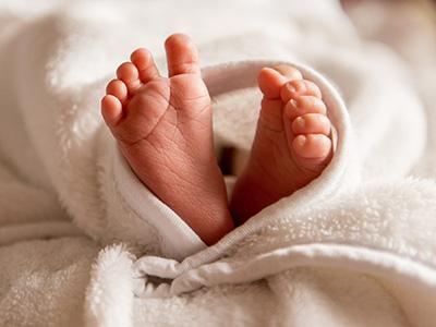 Baby's feet poking out of a blanket.