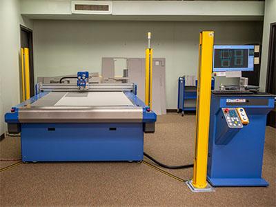 The Kasemake CXD machine with control panel and yellow safety poles in the SCSL basement..