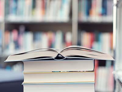 Stack of books on a library table.