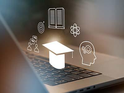 Abstract image of laptop computer with learning icons floating around.