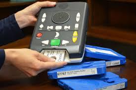 person holding a NLS audio book player