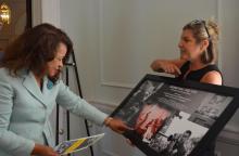 Ashley Till, right, statewide services manager of the S.C. State Library, shows off some of Cecil Williams' notable photography to Aiken City Council member Lessie Price. Price stopped by the Aiken County Historical Museum for an installation of an exhibit displaying Williams' work that opens July 23.