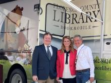Florence Library Director Alan Smith, State Library Director Leesa Aiken, and children's author Will Hillenbrand in front of the new bookmobile. 